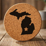 Michigan round cork coaster engraved with the state shape and a star