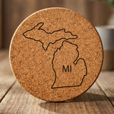 Michigan round cork coaster engraved with the state outline and MI initials