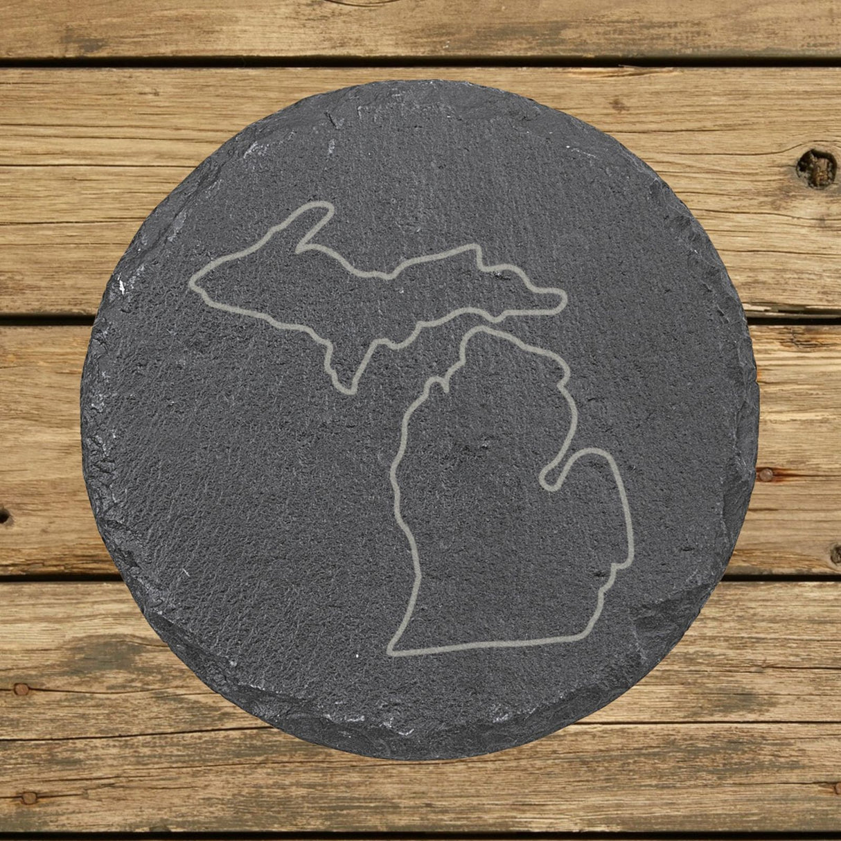 Michigan round slate coaster engraved with a clean state outline