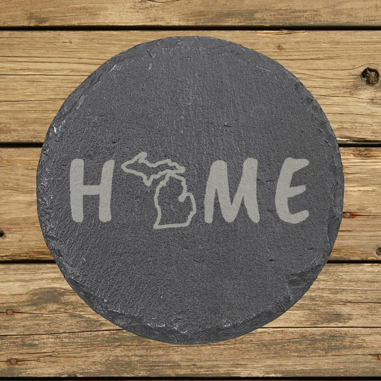 Michigan round slate coaster engraved with HOME using the state outline as the letter O