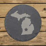 Michigan round slate coaster engraved with the state shape and a star