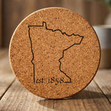 Minnesota round cork coaster engraved with the state outline and est. 1858
