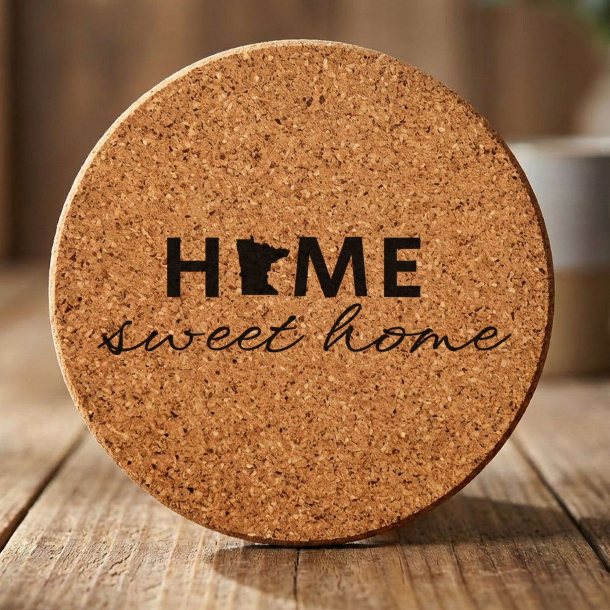 Minnesota round cork coaster engraved with HOME sweet home using the state shape as the letter O