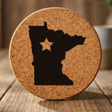 Minnesota round cork coaster engraved with the state shape and a star