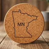 Minnesota round cork coaster engraved with the state outline and MN initials