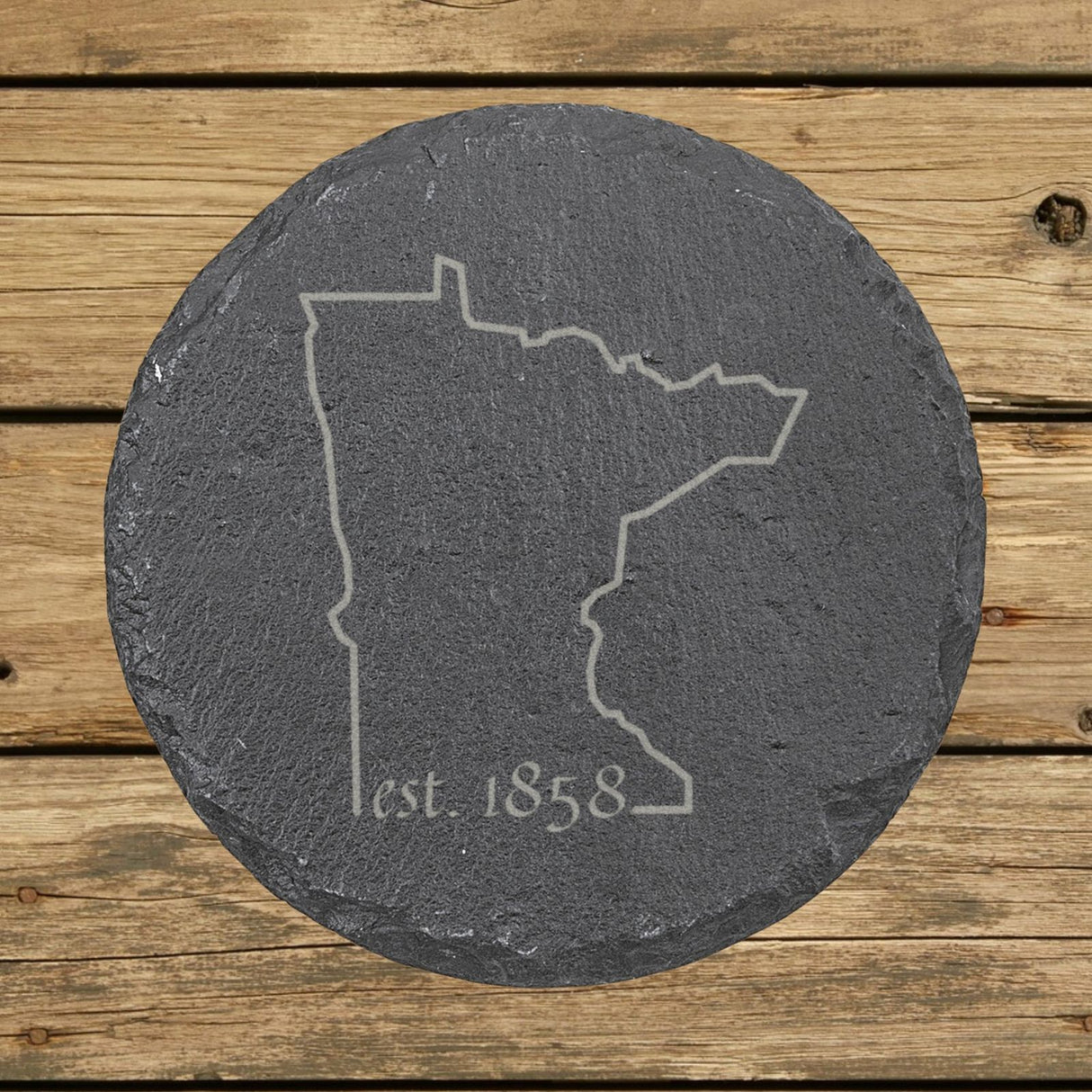 Minnesota round slate coaster engraved with the state outline and est. 1858
