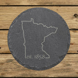 Minnesota round slate coaster engraved with the state outline and est. 1858