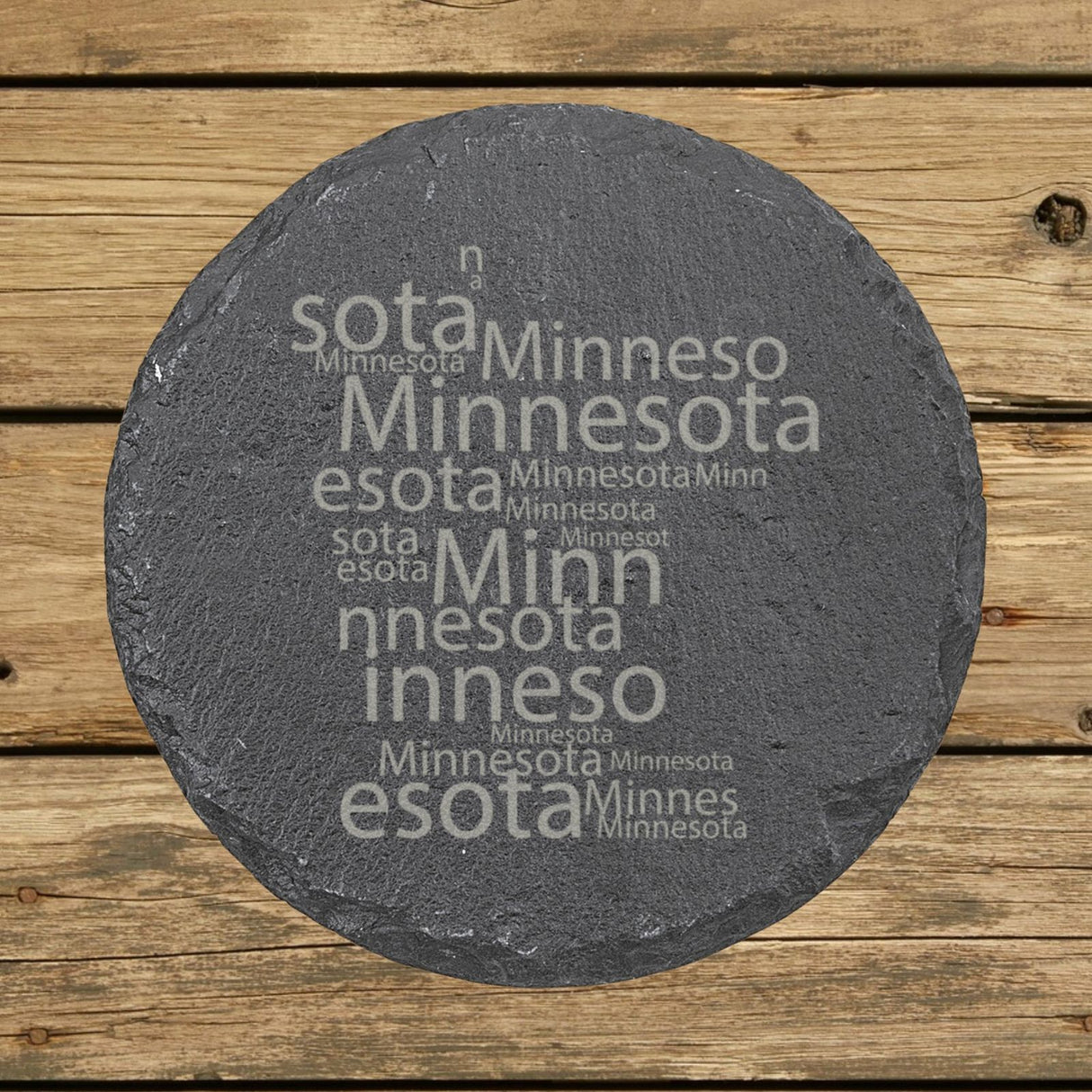 Minnesota round slate coaster engraved with a word cloud of repeating Minnesota text