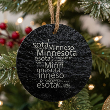 Minnesota round slate Christmas ornament engraved with a word cloud of repeating Minnesota text
