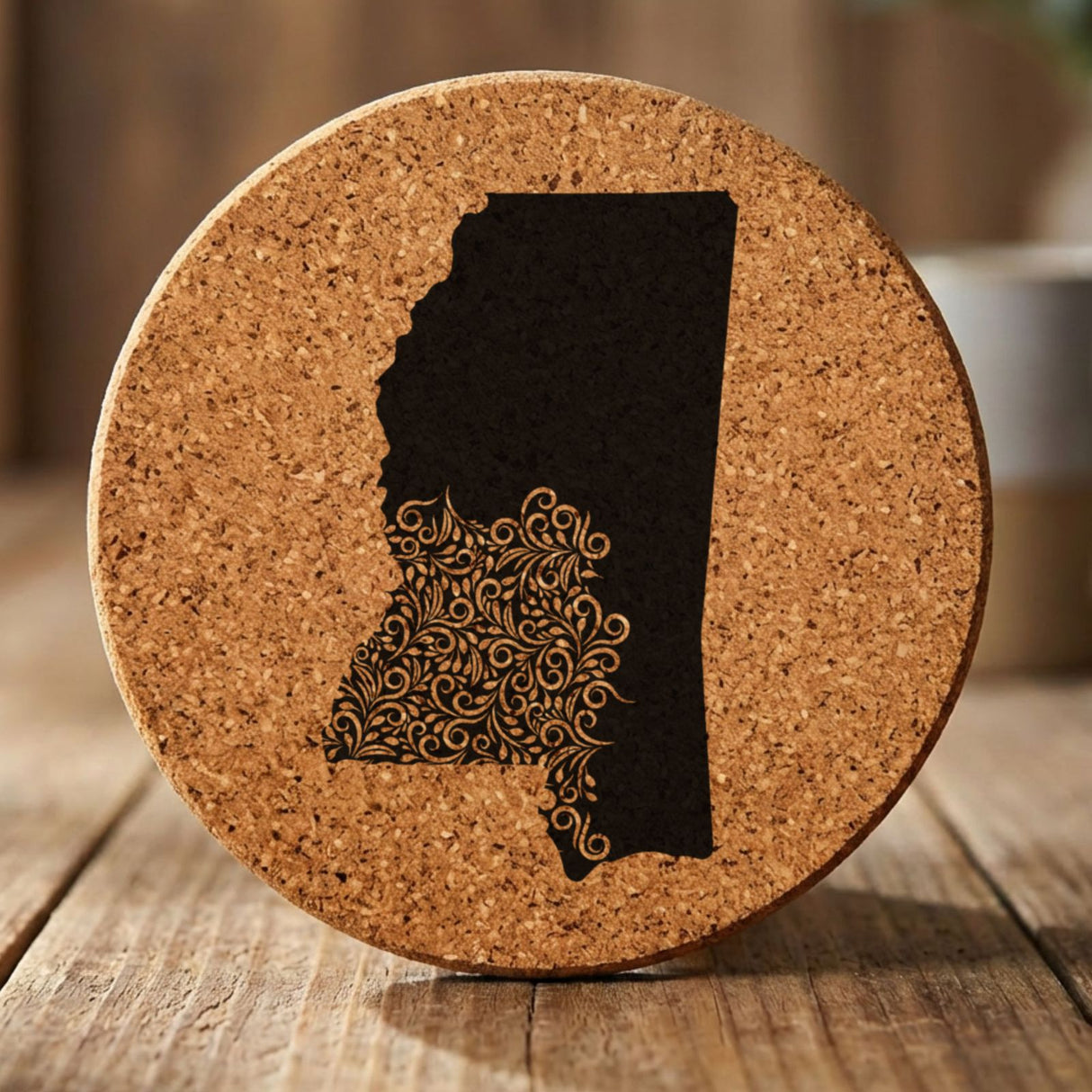 Mississippi round cork coaster engraved with the state shape in ornate floral scrollwork