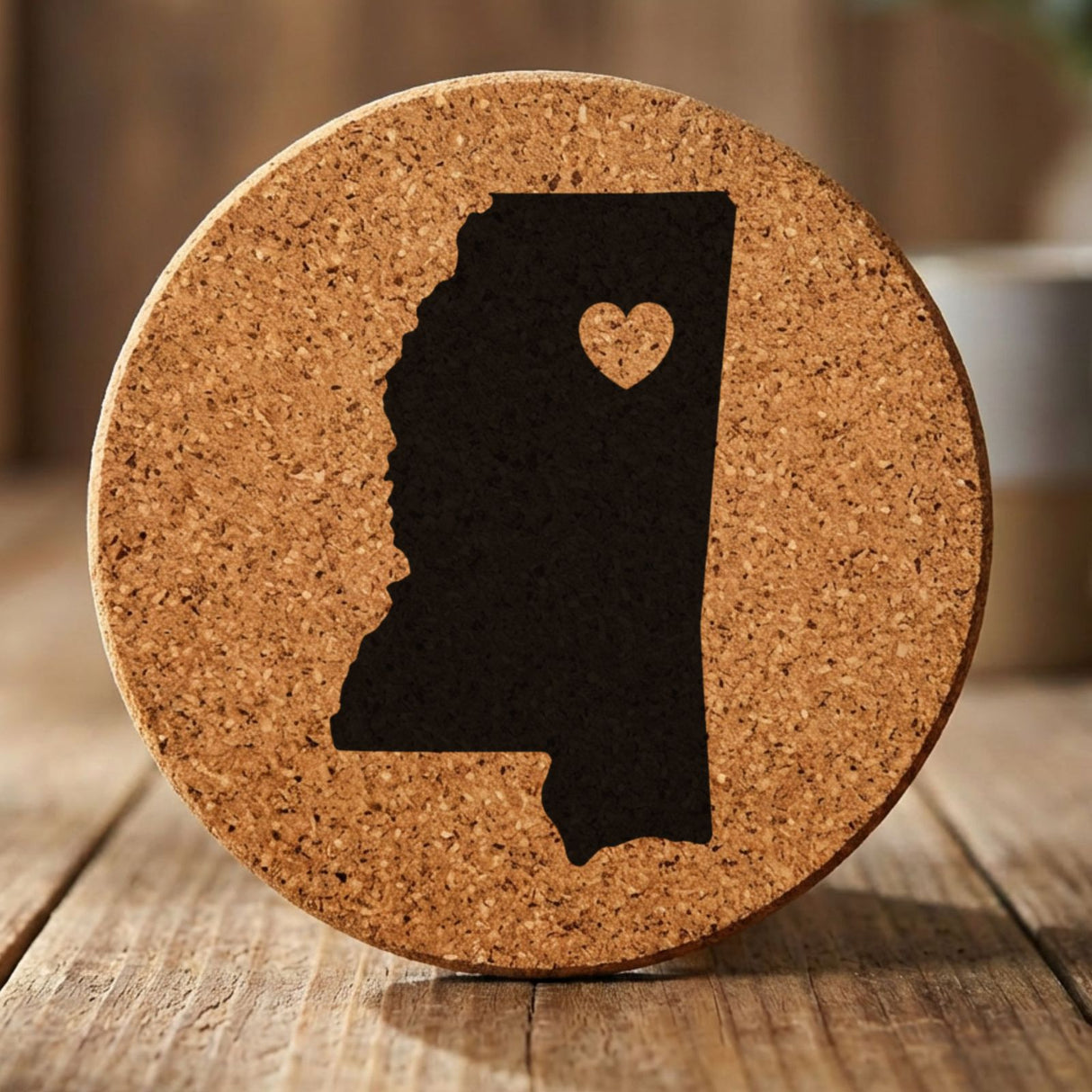 Mississippi round cork coaster engraved with the state shape and a heart