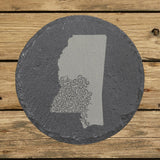 Mississippi round slate coaster engraved with the state shape in ornate floral scrollwork