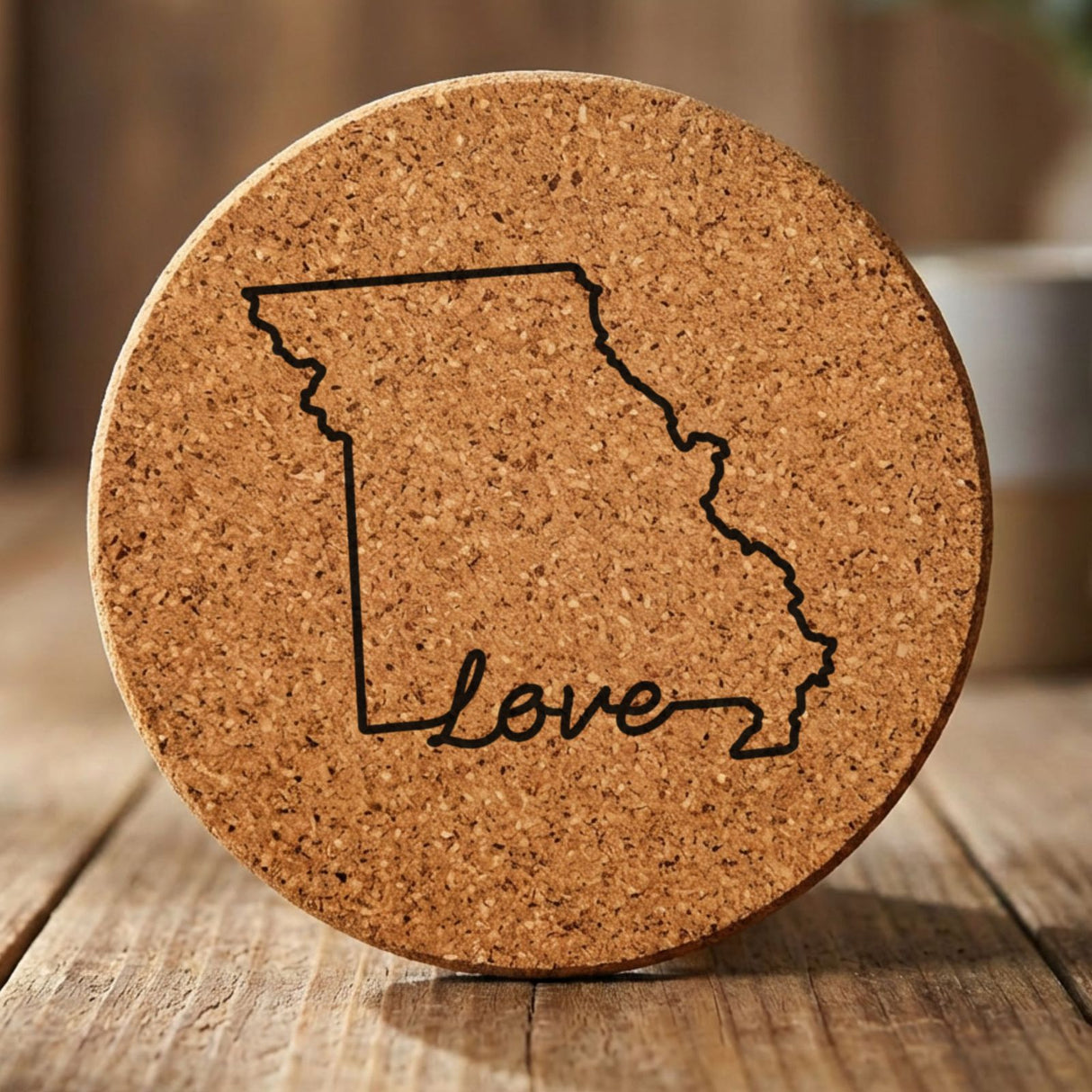 Missouri round cork coaster engraved with a hand-drawn state outline and love in cursive