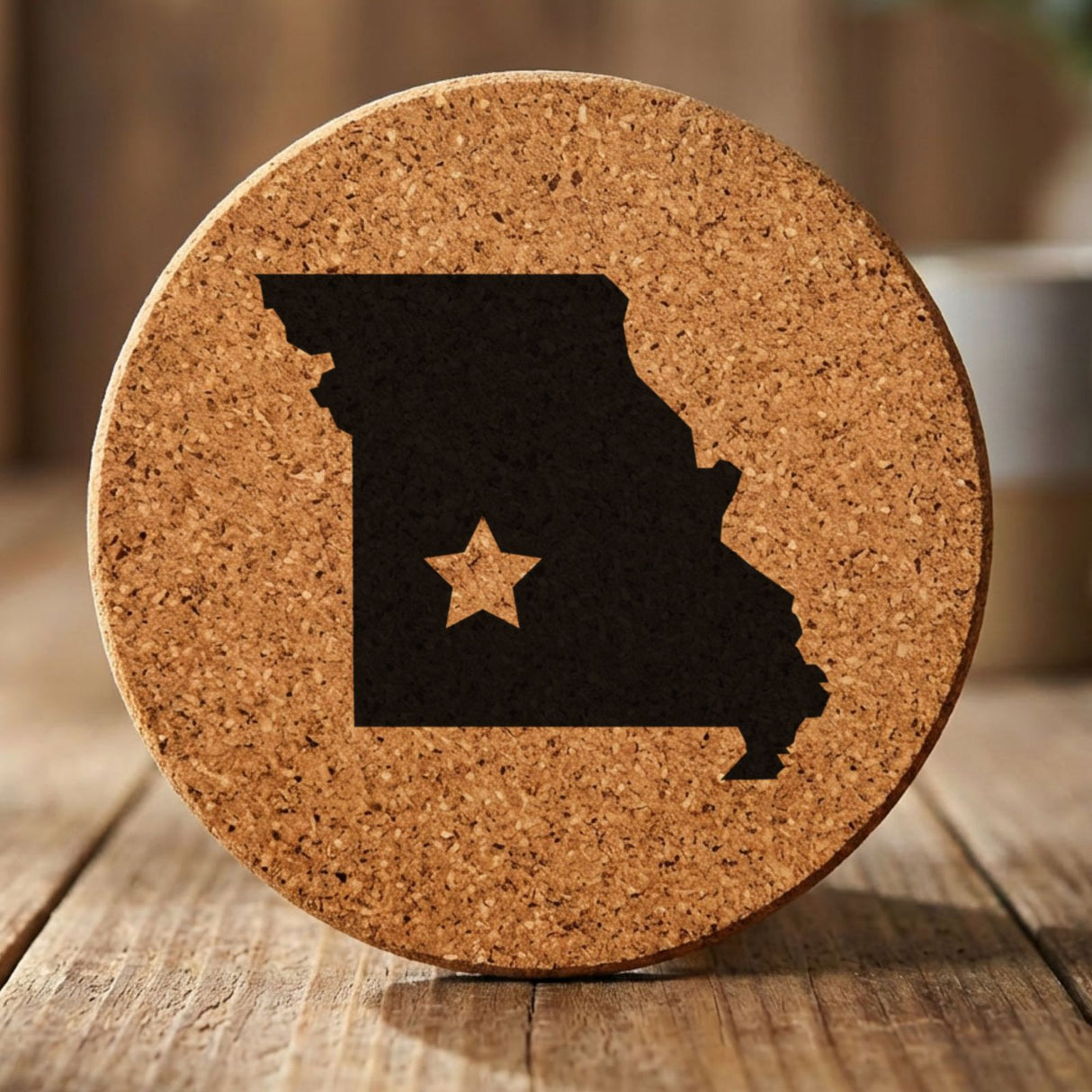 Missouri round cork coaster engraved with the state shape and a star