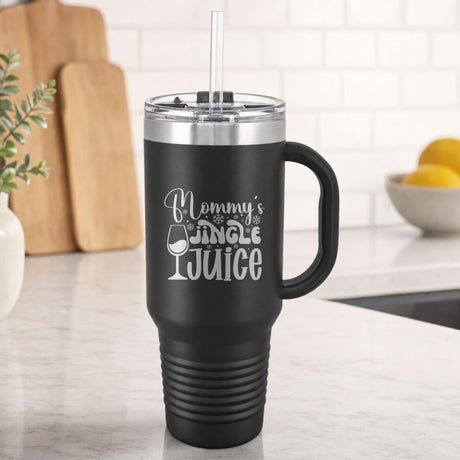 Black 40 oz tumbler with handle and straw laser engraved with "Mommy's Jingle Juice", on a kitchen counter