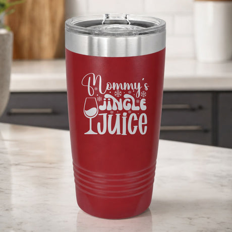 Maroon 20 oz tumbler laser engraved with "Mommy's Jingle Juice", on a kitchen counter