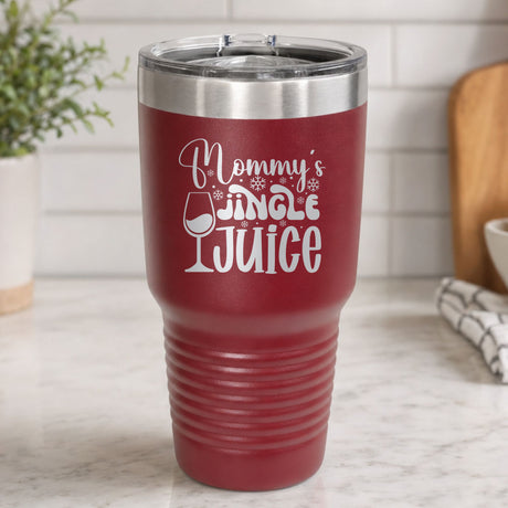 Maroon 30 oz tumbler laser engraved with "Mommy's Jingle Juice", on a kitchen counter