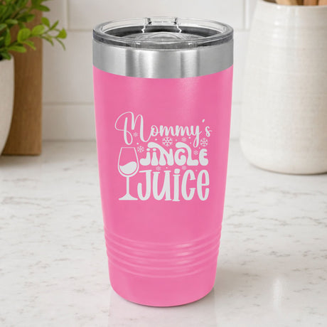 Pink 20 oz tumbler laser engraved with "Mommy's Jingle Juice", on a kitchen counter