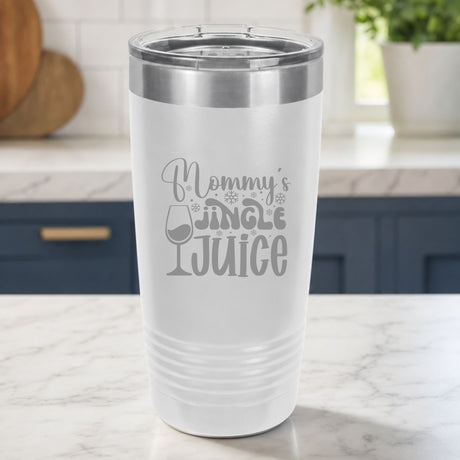 White 20 oz tumbler laser engraved with "Mommy's Jingle Juice", on a kitchen counter