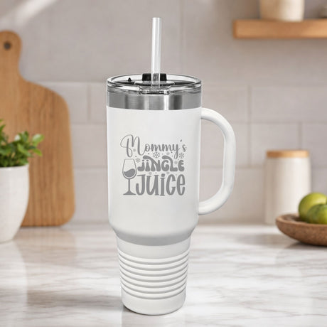 White 40 oz tumbler with handle and straw laser engraved with "Mommy's Jingle Juice", on a kitchen counter