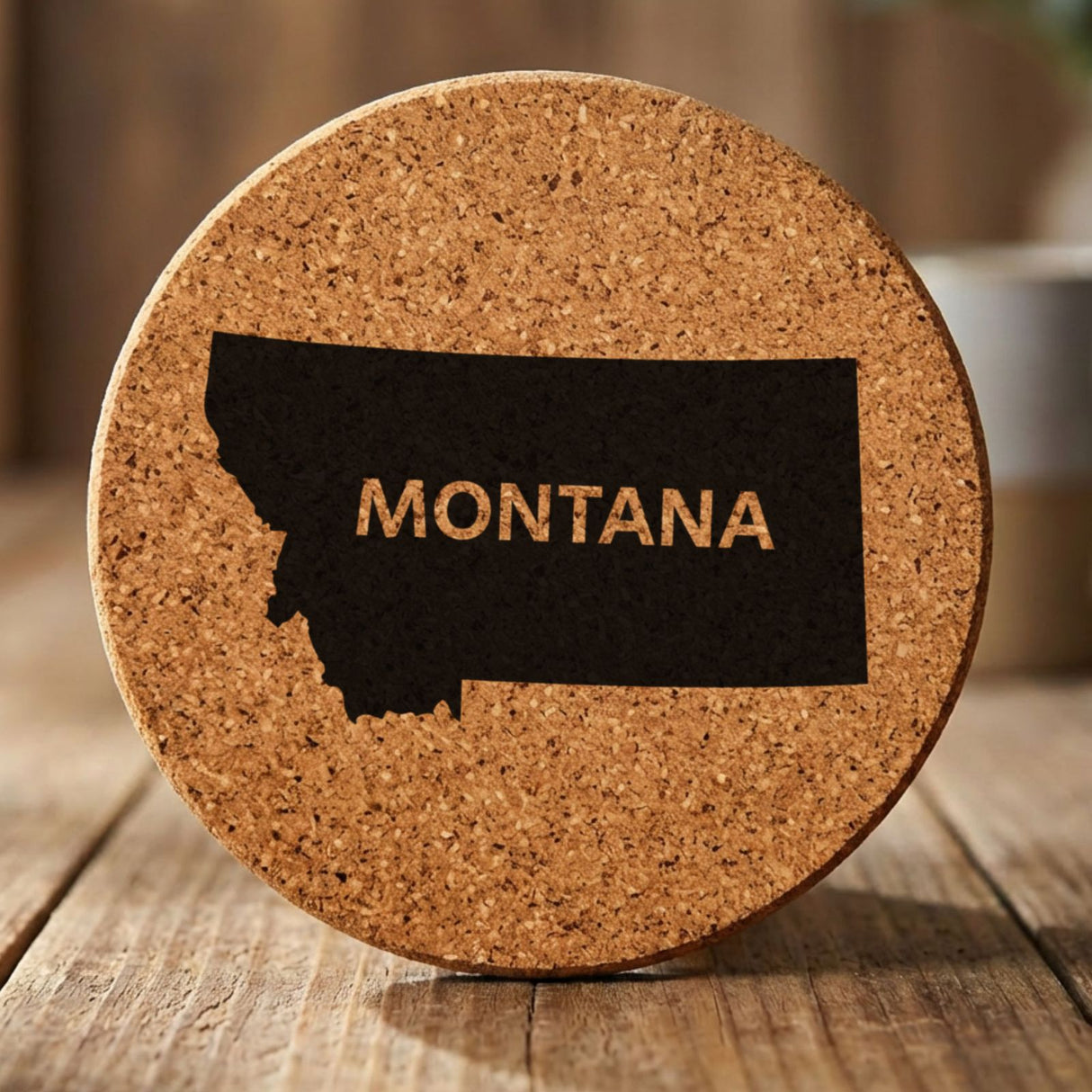 Montana round cork coaster engraved with the state shape and MONTANA in bold lettering