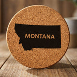 Montana round cork coaster engraved with the state shape and MONTANA in bold lettering