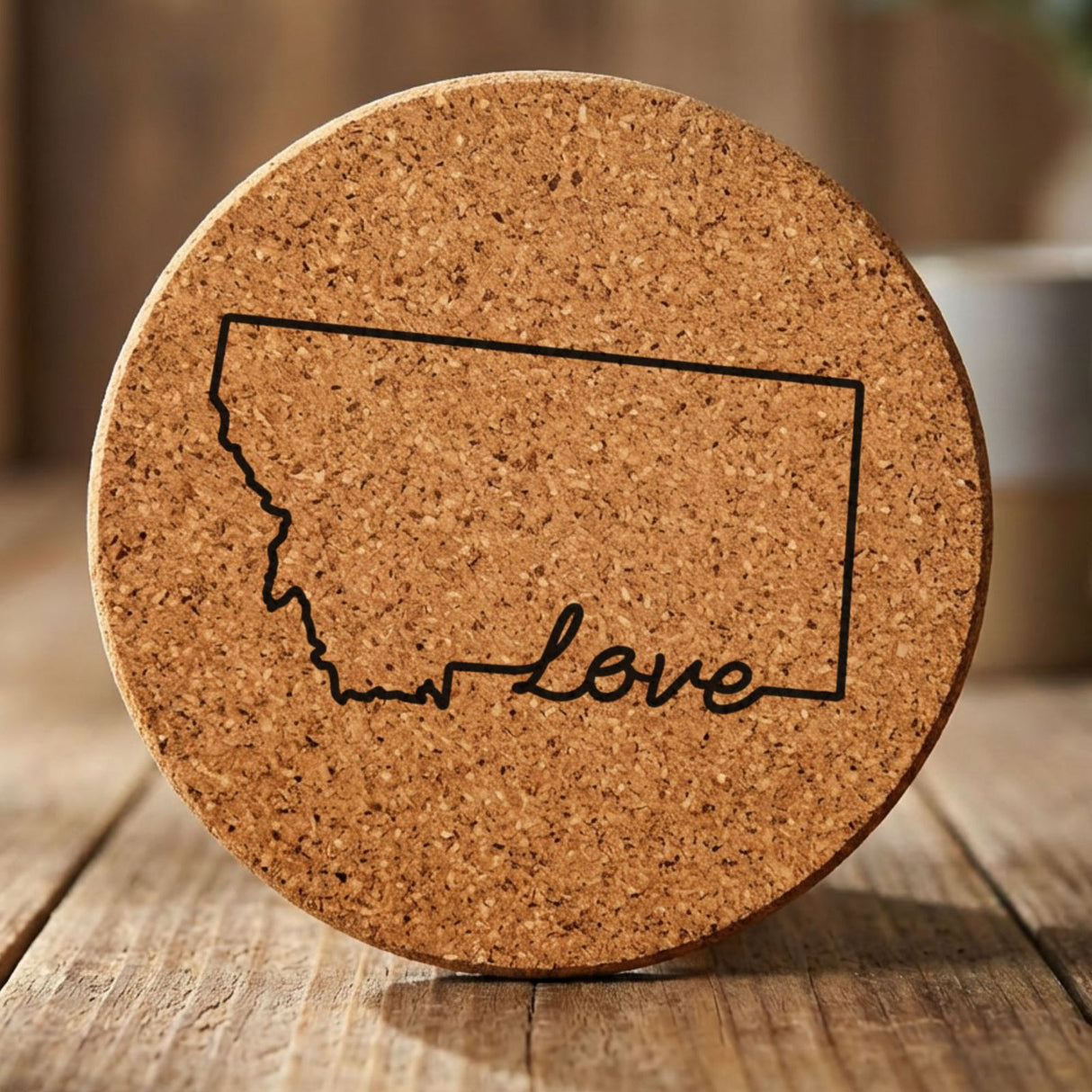 Montana round cork coaster engraved with a hand-drawn state outline and love in cursive