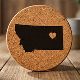 Montana round cork coaster engraved with the state shape and a heart
