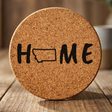 Montana round cork coaster engraved with HOME using the state outline as the letter O