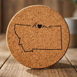 Montana round cork coaster engraved with the state outline and home in script with a heart