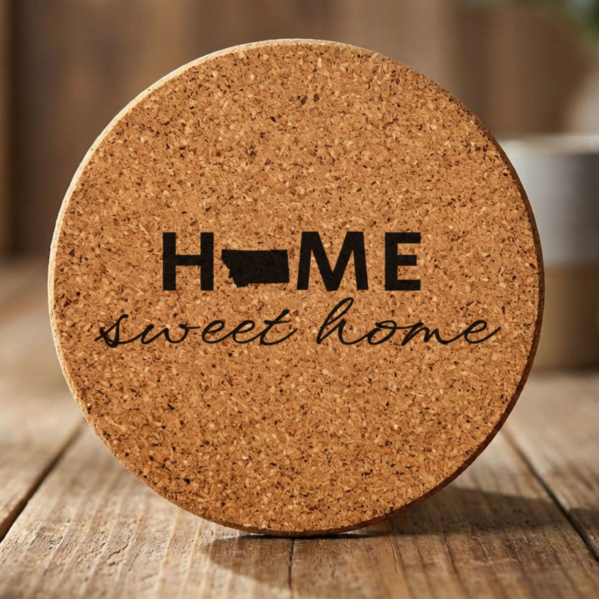 Montana round cork coaster engraved with HOME sweet home using the state shape as the letter O
