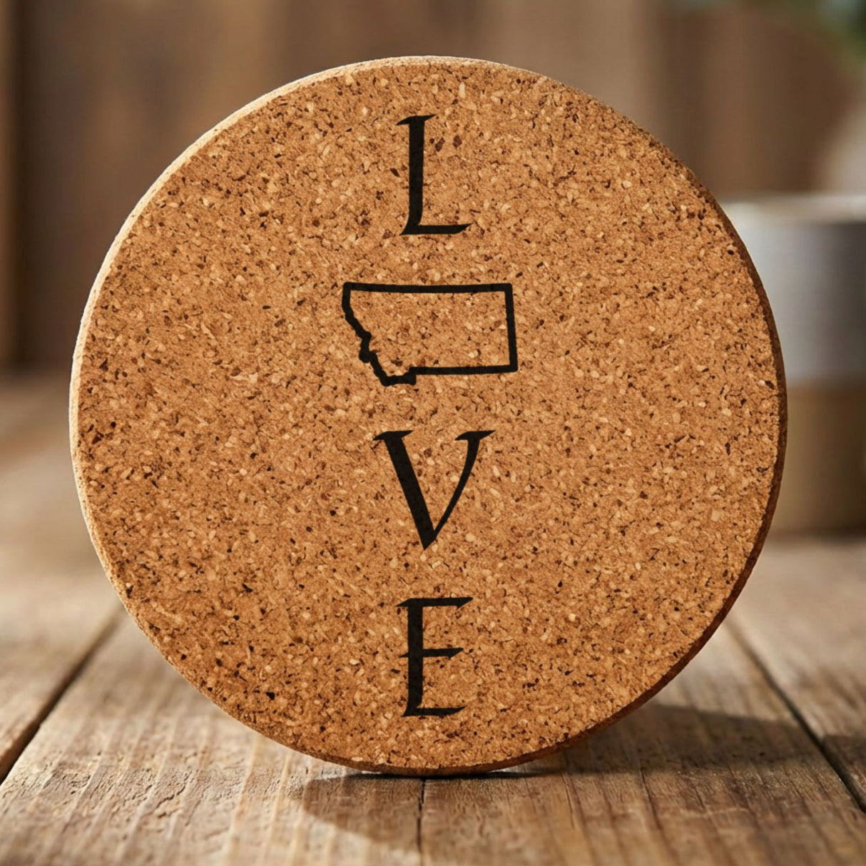 Montana round cork coaster engraved with LOVE stacked vertically using the state as the letter O