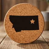 Montana round cork coaster engraved with the state shape and a star