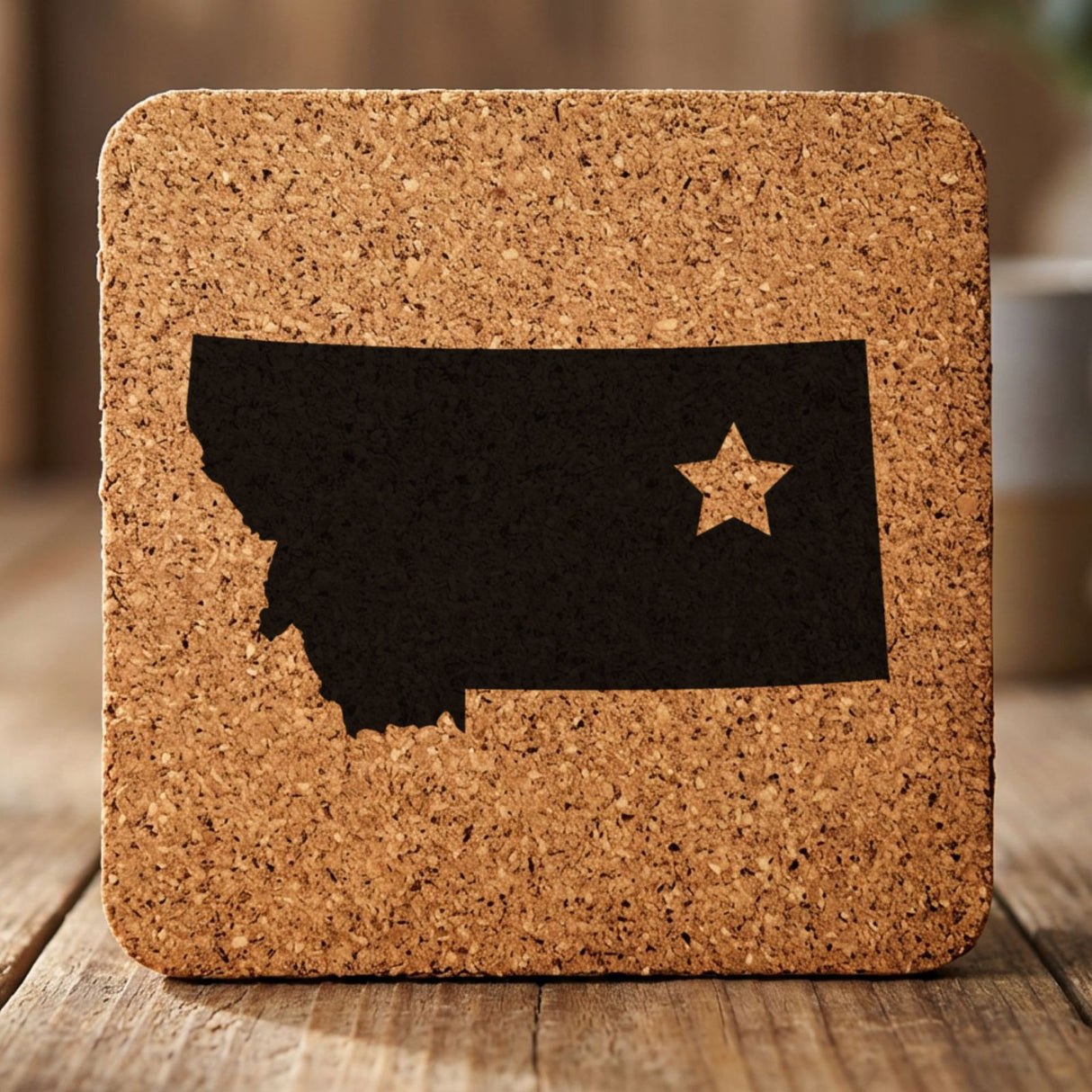 Montana square cork coaster engraved with the state shape and a star