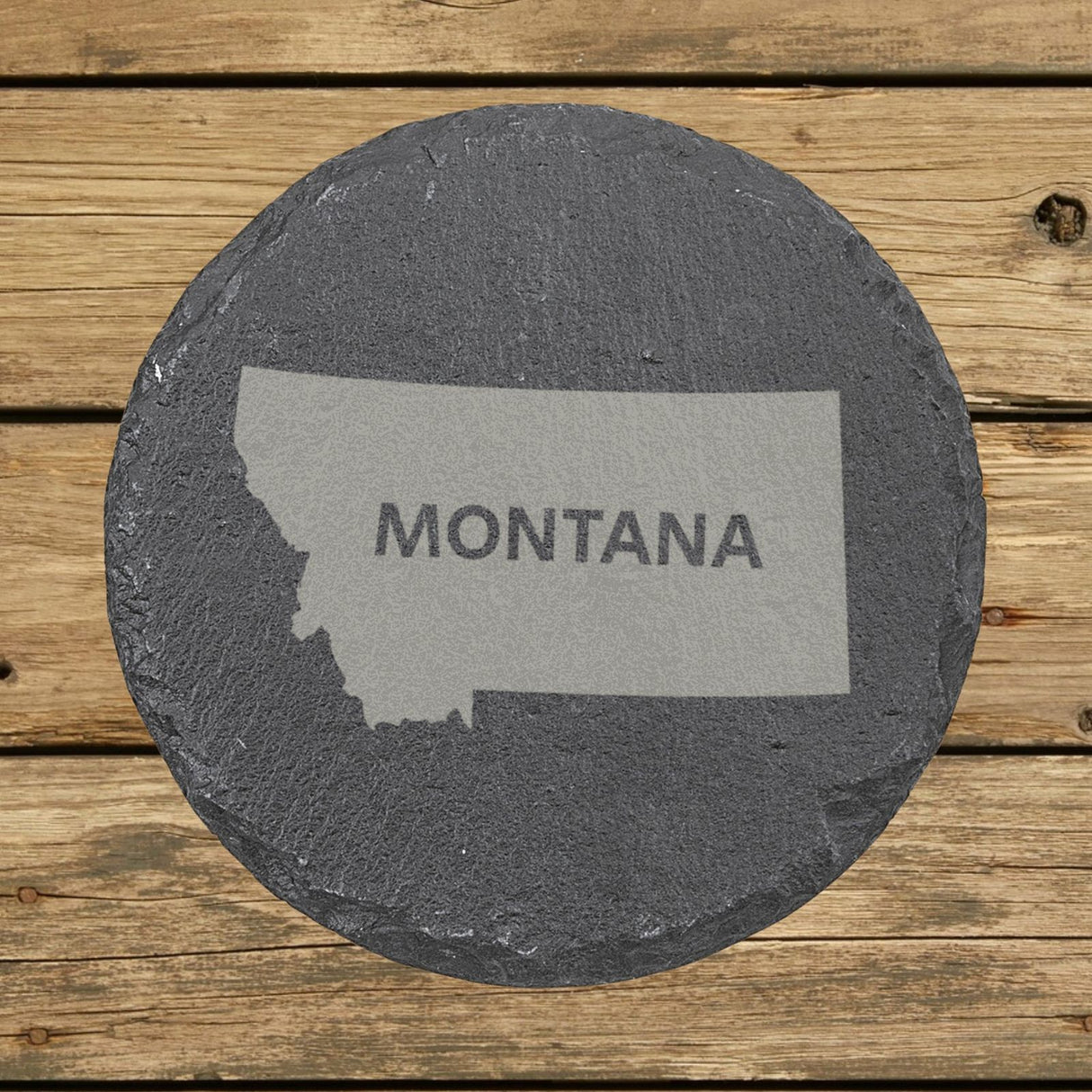 Montana round slate coaster engraved with the state shape and MONTANA in bold lettering