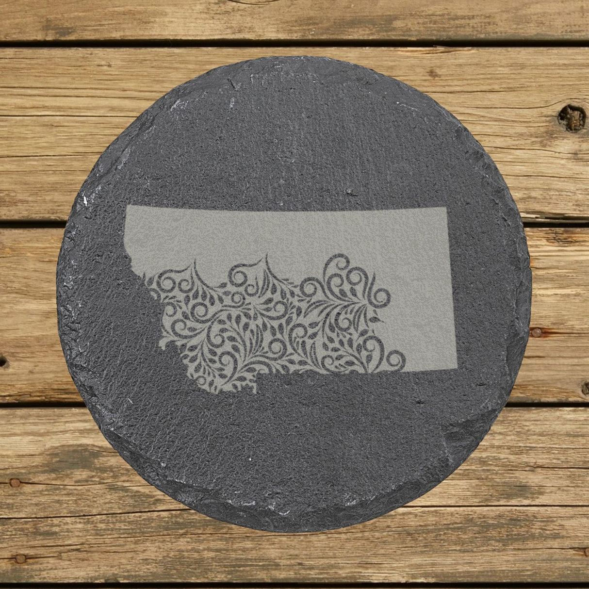 Montana round slate coaster engraved with the state shape in ornate floral scrollwork