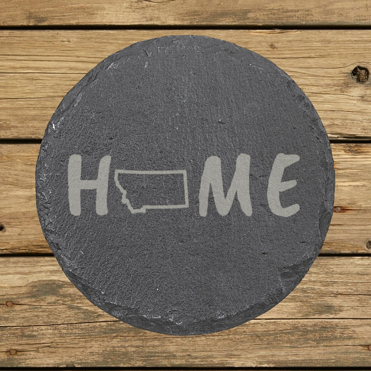 Montana round slate coaster engraved with HOME using the state outline as the letter O