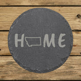 Montana round slate coaster engraved with HOME using the state outline as the letter O