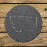 Montana round slate coaster engraved with the state outline and Montana in script lettering