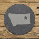 Montana round slate coaster engraved with the state shape and a star