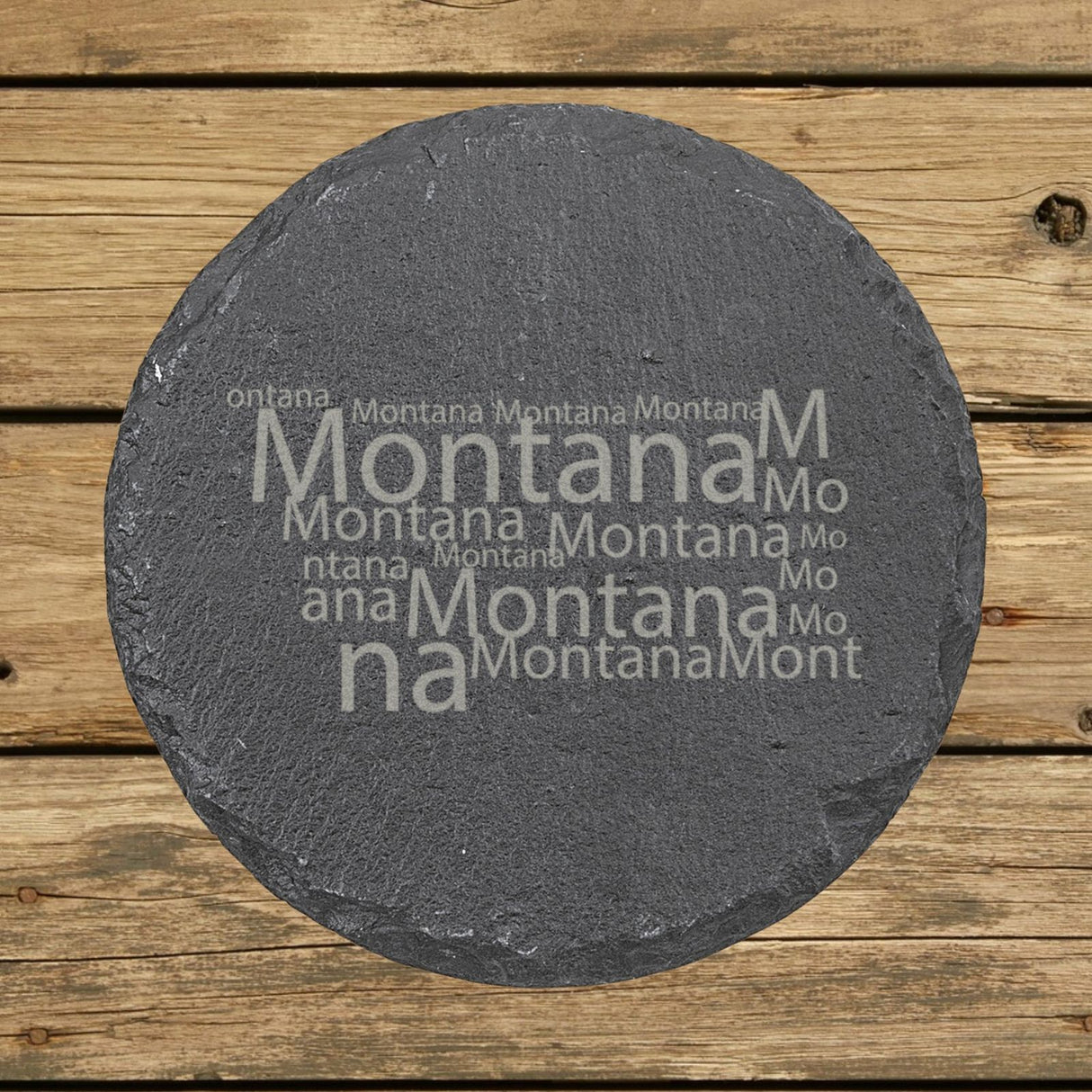 Montana round slate coaster engraved with a word cloud of repeating Montana text