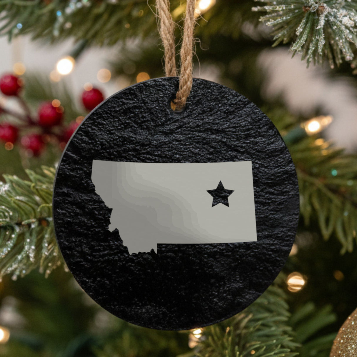 Montana round slate Christmas ornament engraved with the state shape and a star