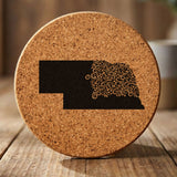 Nebraska round cork coaster engraved with the state shape in ornate floral scrollwork