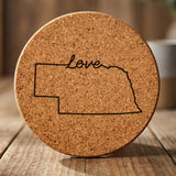 Nebraska round cork coaster engraved with a hand-drawn state outline and love in cursive