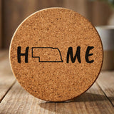 Nebraska round cork coaster engraved with HOME using the state outline as the letter O
