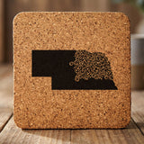 Nebraska square cork coaster engraved with the state shape in ornate floral scrollwork