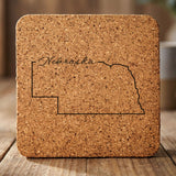 Nebraska square cork coaster engraved with the state outline and Nebraska in script lettering