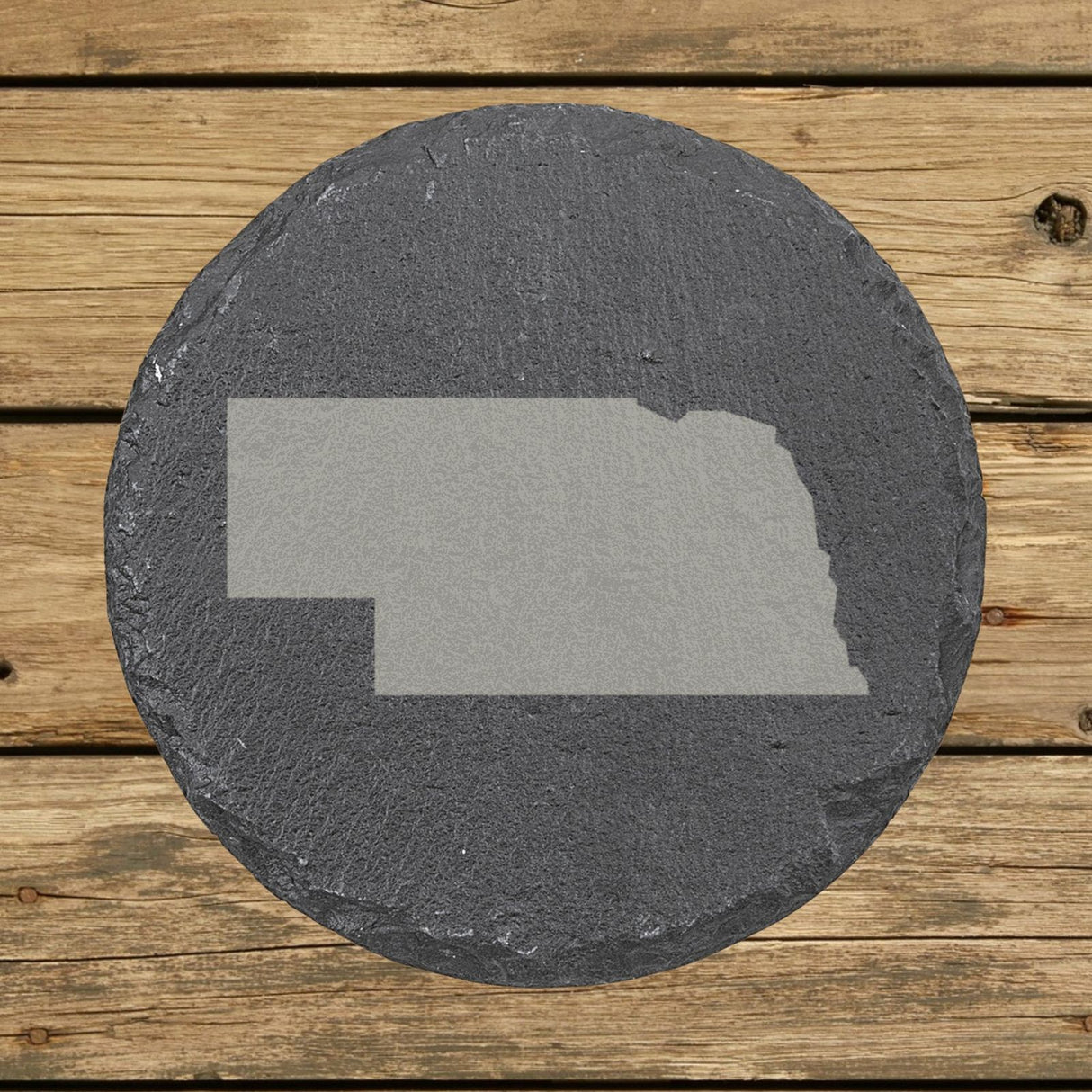 Nebraska round slate coaster with the full state shape engraved