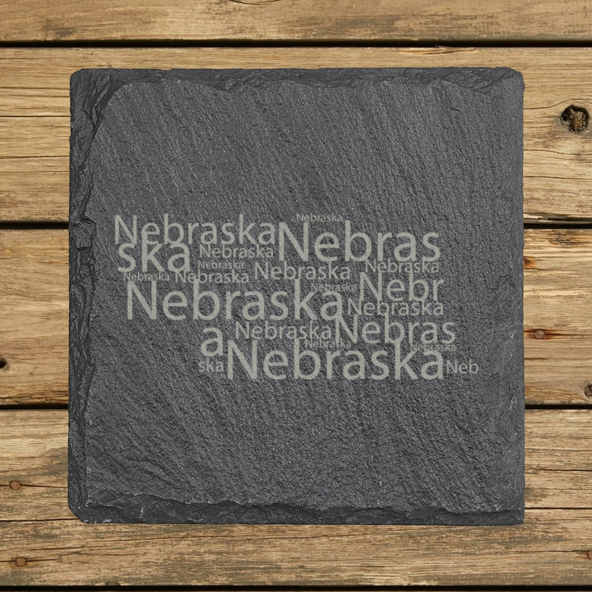 Nebraska square slate coaster engraved with a word cloud of repeating Nebraska text
