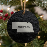 Nebraska round slate Christmas ornament engraved with the state shape and NEBRASKA in bold lettering